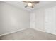Bedroom featuring neutral paint, carpet, ceiling fan, and two doors at 4645 Valais Ct # 135, Alpharetta, GA 30022