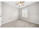 Bedroom featuring neutral paint, carpet, ceiling fan, and a window at 4645 Valais Ct # 135, Alpharetta, GA 30022