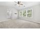 Bright bedroom with carpet, a ceiling fan, and multiple windows for ample natural light at 4645 Valais Ct # 135, Alpharetta, GA 30022