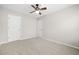 Bedroom featuring neutral paint, carpet, ceiling fan, and two doors at 4645 Valais Ct # 135, Alpharetta, GA 30022