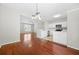 Open-concept dining area with hardwood floors, modern light fixture, and seamless flow to the kitchen at 4645 Valais Ct # 135, Alpharetta, GA 30022