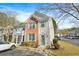Inviting two-story townhome with brick and siding, complemented by lush landscaping and dedicated parking at 4645 Valais Ct # 135, Alpharetta, GA 30022