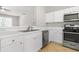 Modern kitchen with white cabinetry, stainless steel appliances, and sleek countertops at 4645 Valais Ct # 135, Alpharetta, GA 30022