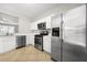 Well-equipped kitchen featuring stainless steel appliances, tile flooring, and ample counter space at 4645 Valais Ct # 135, Alpharetta, GA 30022