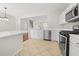 Bright kitchen featuring white cabinets, stainless steel appliances, and an island with seating at 4645 Valais Ct # 135, Alpharetta, GA 30022