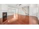 Open-concept living room with hardwood floors, fireplace, and staircase at 4645 Valais Ct # 135, Alpharetta, GA 30022