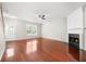 Bright living room features gleaming hardwood floors, a cozy fireplace, and a large window at 4645 Valais Ct # 135, Alpharetta, GA 30022