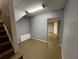 Finished basement area with stairs, grey walls, and tan floors at 4811 West Lake Se Dr, Conyers, GA 30094