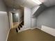 Unfinished basement area with grey walls, stairs, and beige floor at 4811 West Lake Se Dr, Conyers, GA 30094