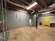 Unfinished basement with utility connections and a bright yellow exit door at 4811 West Lake Se Dr, Conyers, GA 30094