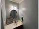 Charming half bath with gray walls, lovely mirror, and attractive décor at 4811 West Lake Se Dr, Conyers, GA 30094