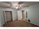 Bedroom featuring forest wall decor, neutral carpeting, and ceiling fan at 4811 West Lake Se Dr, Conyers, GA 30094