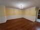 Spacious dining room with hardwood floors, wainscoting, crown molding and a chandelier at 4811 West Lake Se Dr, Conyers, GA 30094