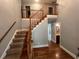 Grand foyer with a staircase, hardwood floors, and views of a bathroom at 4811 West Lake Se Dr, Conyers, GA 30094