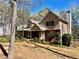Beautiful two-story home with brick and vinyl siding, complemented by a well-maintained lawn and mature trees at 4811 West Lake Se Dr, Conyers, GA 30094