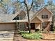 Charming two-story home with a brick and tan siding exterior and well-manicured front yard at 4811 West Lake Se Dr, Conyers, GA 30094