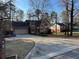 Well-kept home with a long driveway, attached garage, and mature landscaping at 4811 West Lake Se Dr, Conyers, GA 30094
