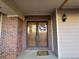 Inviting front entrance featuring double doors, brick accents, and a welcoming 