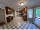 Open concept kitchen featuring wood cabinets, stainless appliances, and checkered flooring at 4811 West Lake Se Dr, Conyers, GA 30094