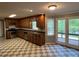 Spacious kitchen with wood cabinets, stainless steel appliances and checkered floor at 4811 West Lake Se Dr, Conyers, GA 30094