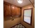Functional laundry room featuring wooden cabinets and window at 4811 West Lake Se Dr, Conyers, GA 30094