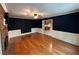 Spacious living room with wood flooring, fireplace and dark blue paint for a calm and comforting effect at 4811 West Lake Se Dr, Conyers, GA 30094