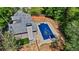 Aerial view of a backyard with a covered swimming pool, surrounded by a concrete patio at 4811 West Lake Se Dr, Conyers, GA 30094