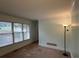 Carpeted room with large windows offering plenty of natural light at 4811 West Lake Se Dr, Conyers, GA 30094