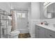 Bathroom with a tub and shower, gray vanity, white subway tile, and linen storage at 2587 Lancaster Dr, Atlanta, GA 30344