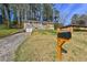 Charming brick home featuring an attached garage, lush greenery, and a mailbox for added convenience at 2587 Lancaster Dr, Atlanta, GA 30344