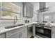 Charming kitchen featuring stainless steel appliances, gray cabinets, and bright, natural light at 2587 Lancaster Dr, Atlanta, GA 30344