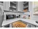 Compact kitchen featuring gray cabinets, white countertops, a microwave, and subway tile backsplash at 2587 Lancaster Dr, Atlanta, GA 30344