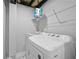 Laundry area equipped with modern washer and dryer, along with storage shelves for convenience at 2587 Lancaster Dr, Atlanta, GA 30344