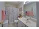 Cozy bathroom features a sink, floral shower curtain, and towels; perfect for relaxation and comfort at 3000 Gallery Walk, Snellville, GA 30039