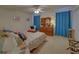 Cozy bedroom with floral bedding, natural light, and a comfortable chair; furnished with a classic dresser at 3000 Gallery Walk, Snellville, GA 30039