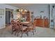 Elegant dining room with a wooden table set for six, a chandelier, and traditional decor at 3000 Gallery Walk, Snellville, GA 30039
