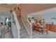 Inviting entryway with a staircase leading to the upper level and an adjacent dining area with a chandelier at 3000 Gallery Walk, Snellville, GA 30039