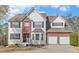 Charming two-story home with a combination of brick and white siding plus an attached two-car garage at 3000 Gallery Walk, Snellville, GA 30039
