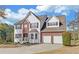 Charming two-story home with a combination of brick and white siding, attached garage, and landscaped yard at 3000 Gallery Walk, Snellville, GA 30039