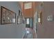 Hallway featuring a high ceiling, framed artwork, and a glimpse of the front door with decorative glass at 3000 Gallery Walk, Snellville, GA 30039