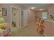 Light-filled hallway with neutral carpet, white trim, and doorways leading to bedrooms and living spaces at 3000 Gallery Walk, Snellville, GA 30039