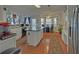 Spacious kitchen with white cabinets, an island with a countertop, and wood flooring at 3000 Gallery Walk, Snellville, GA 30039