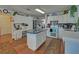 Bright kitchen featuring white cabinets, a center island with a countertop, and modern appliances at 3000 Gallery Walk, Snellville, GA 30039