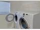 Clean laundry room features modern washer and dryer units, and storage at 3000 Gallery Walk, Snellville, GA 30039