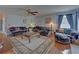 Cozy living room offers comfortable seating, a ceiling fan, and ample space at 3000 Gallery Walk, Snellville, GA 30039