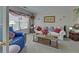 Cozy living room featuring a comfortable sofa, patterned pillows, and natural light from a window at 3000 Gallery Walk, Snellville, GA 30039