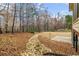Expansive backyard with mature trees and a natural rock drainage feature at 3211 Blaisdell Rd, Buford, GA 30519