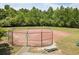 Fenced in community ball field with picnic tables and mature trees at 3211 Blaisdell Rd, Buford, GA 30519