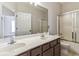 Bright bathroom with double sinks, ample countertop space, and a shower and tub combination at 3211 Blaisdell Rd, Buford, GA 30519