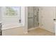 Bathroom with a soaking tub next to a window and a glass door shower at 3211 Blaisdell Rd, Buford, GA 30519